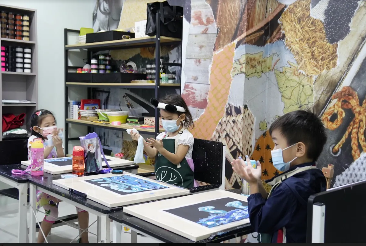 An OpenKids art studio full of children painting