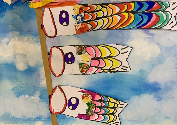 Koinobori carp streamers in washi paper over a watercolour sky