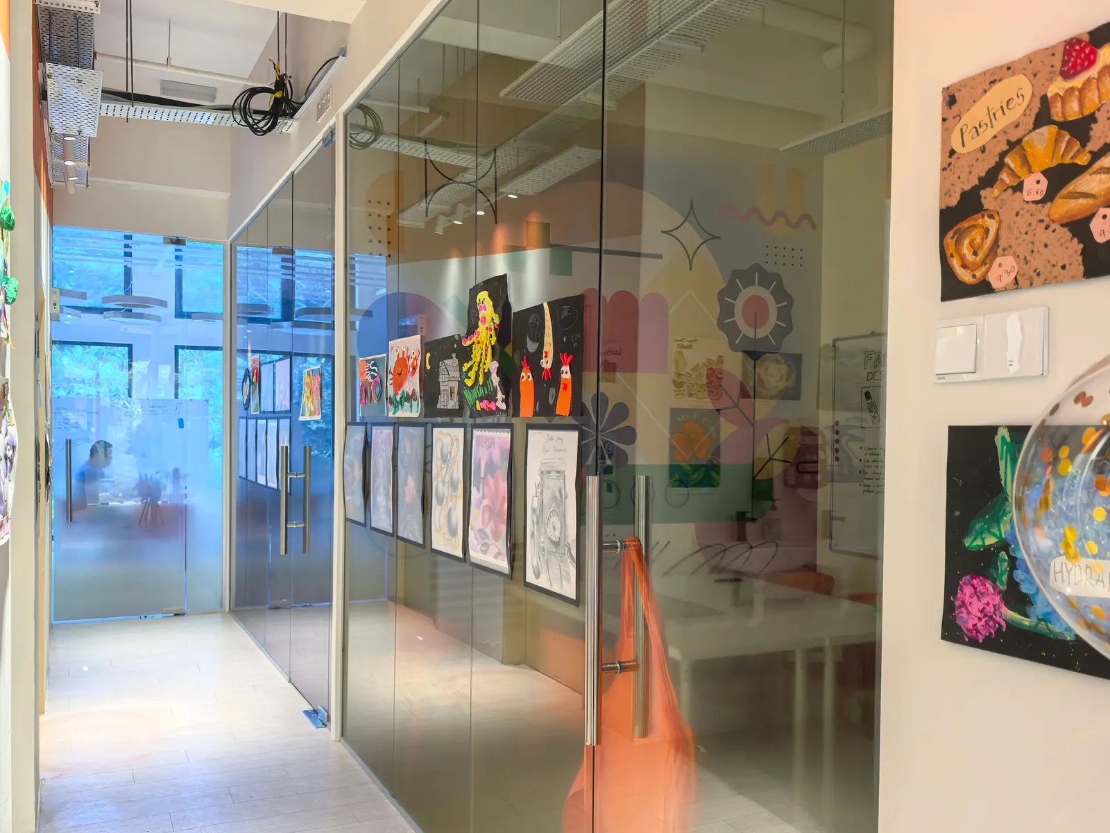 Glass-walled studios along the gallery corridor