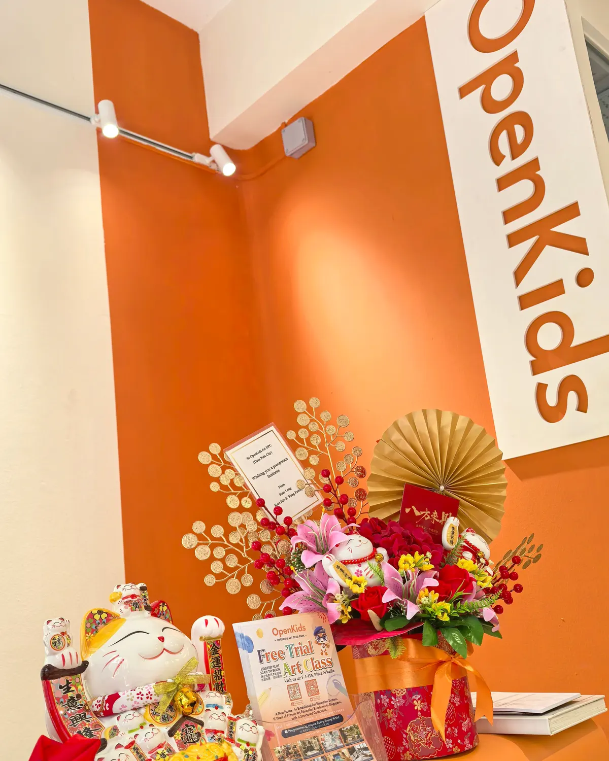The OpenKids sign on the orange wall