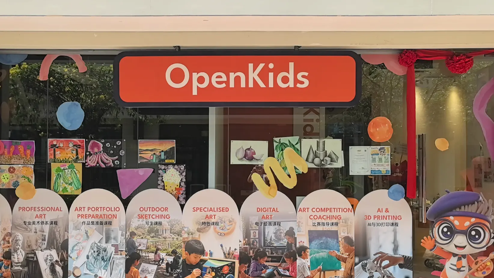 The OpenKids storefront at Plaza Arkadia with its eight programme posters
