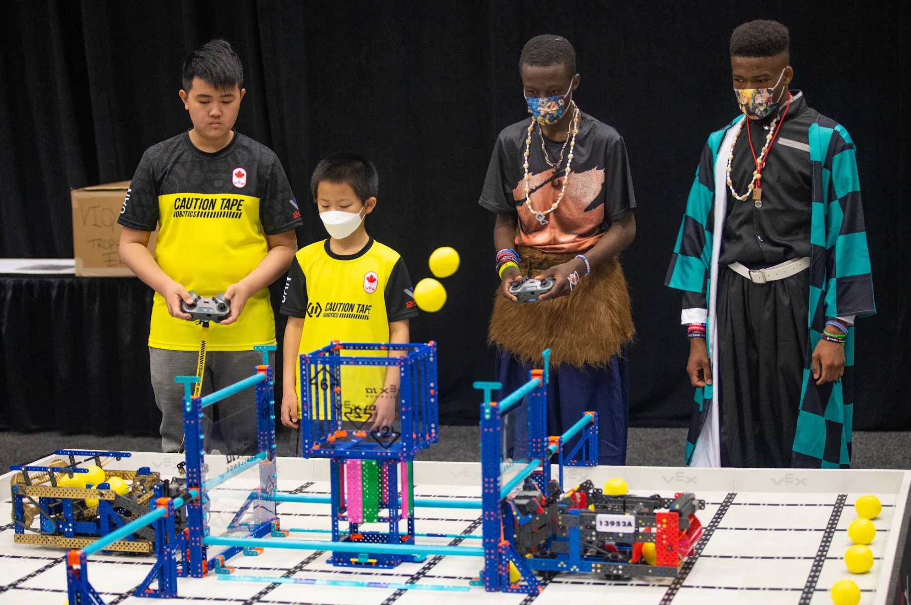 OpenKids students driving their robots in competition